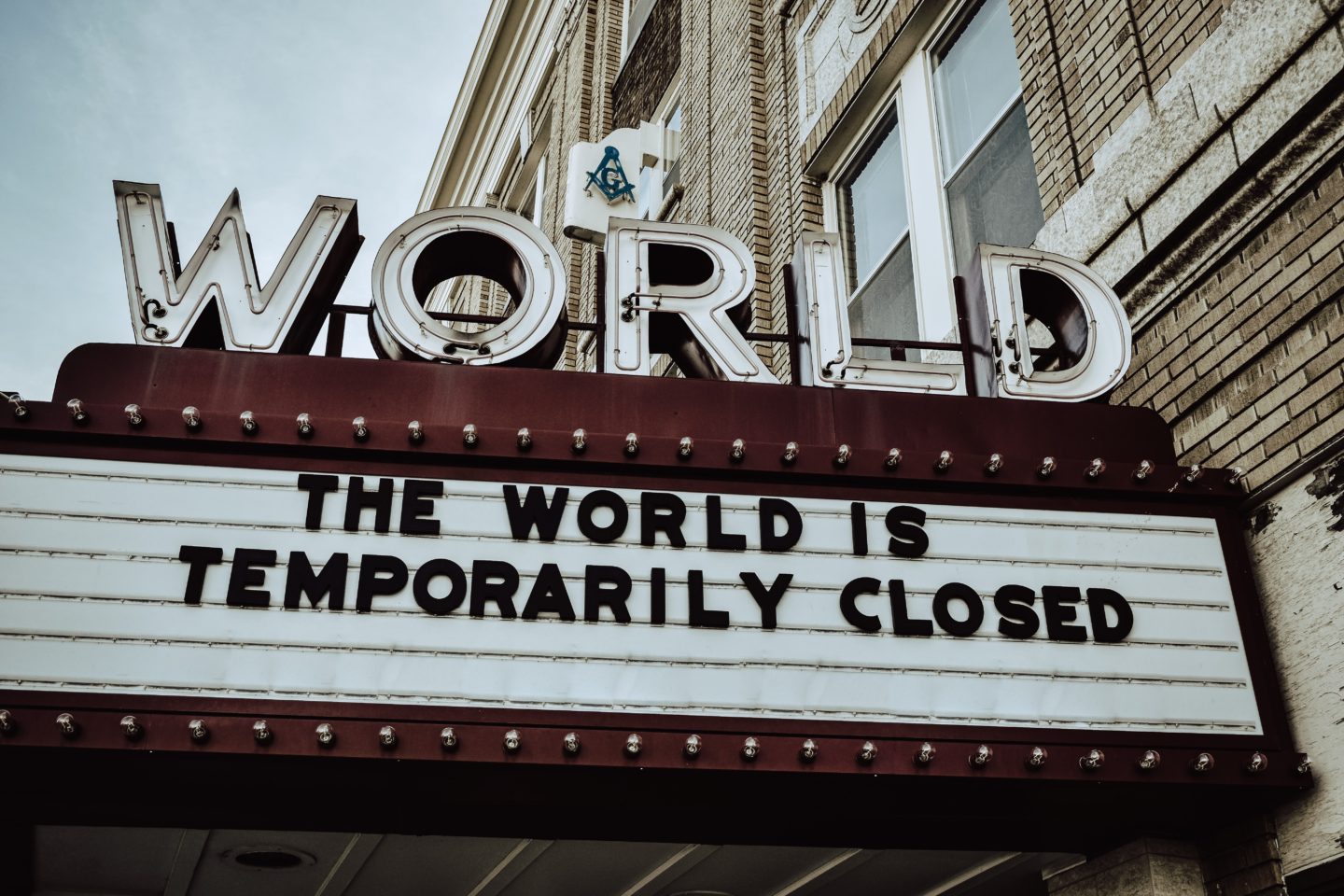 Sign reading 'World: The World Is Temporarily Closed'